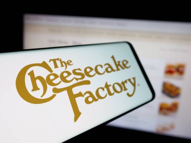 Stuttgart, Almanya - 11-14-2025: İnternet sitesinin önünde ekranda The Cheesecake Factory Incorporated şirketinin logosuna sahip akıllı telefon. Telefon ekranının soluna odaklan.