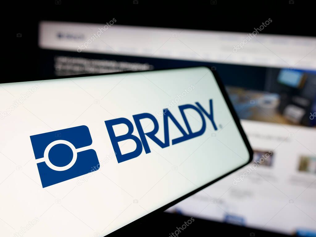 Stuttgart, Germany - 11-13-2025: Smartphone with logo of US manufacturing company Brady Corporation on screen in front of website. Focus on left of phone display.