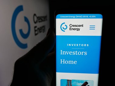 Stuttgart, Almanya - 11-26-2025: ABD petrol şirketi Crescent Energy Company 'nin web sayfası olan akıllı telefon sahibi kişi logonun önünde ekranda. Telefon ekranının merkezine odaklan.
