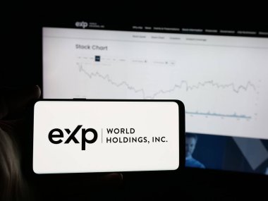Stuttgart, Almanya - 12-10-2025: Emlak şirketi eXp World Holding Inc. 'nin logosuna sahip akıllı telefon web sitesinin önünde ekranda. Telefon ekranına odaklan.