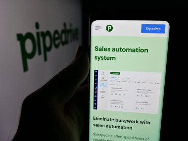 Stuttgart, Almanya - 12-12-2025: Estonya 'lı CRM yazılım şirketi Pipedrive' ın web sayfası olan cep telefonu logonun önünde ekranda. Telefon ekranının merkezine odaklan.