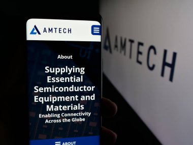 Stuttgart, Almanya - 01-26-2026: ABD 'li yarı iletken şirket Amtech Systems Inc.' in web sayfası ile akıllı telefon sahibi kişi logonun önünde ekranda. Telefon ekranının merkezine odaklan.