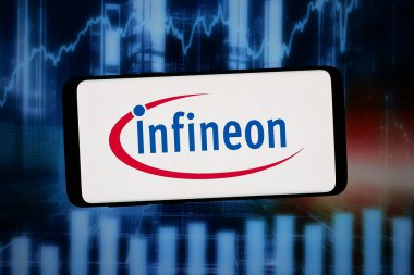 Stuttgart, Almanya - 02-12-2026: Bu resimde, Alman şirketi Infineon Technologies 'in logosu bilgisayar ekranında soyut bir arkaplanda akıllı telefon önünde sergilenmektedir..
