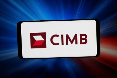Stuttgart, Almanya - 02-27-2026: Bu fotoğraf illüstrasyonunda, Malezyalı şirket CIMB Group Holding Berhad 'ın logosu bilgisayar ekranında soyut bir arkaplanda akıllı bir telefon önünde sergileniyor.