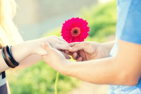 Engagement ring on a flower — Stock Photo, Image