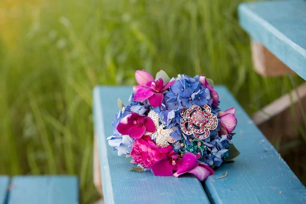bridal bouquet with orchids of violet and pink color jewelry