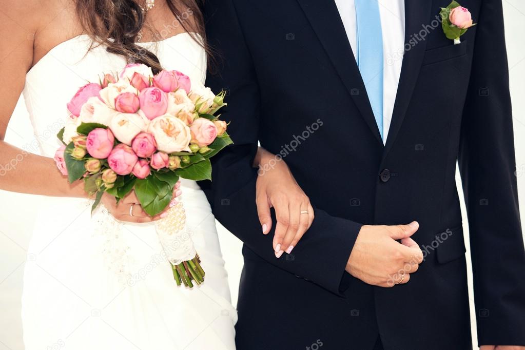 groom holds the bride by a hand