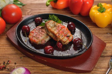 Bir tavada kiraz soslu kızarmış domuz eti