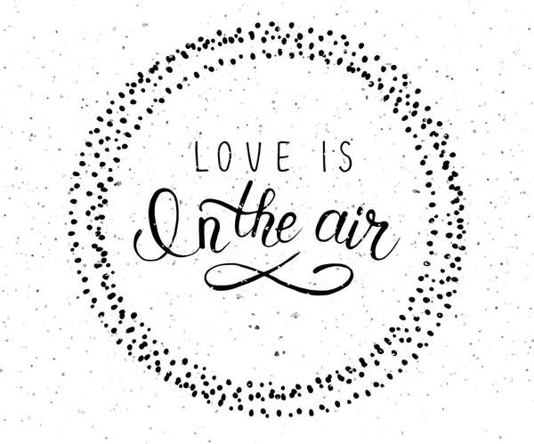 Hand sketched 'Love is in the air text'. Valentine's Day typograph — ストックベクタ