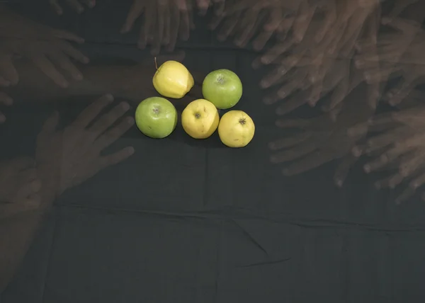 Five apples, green and yellow. hands that grab.