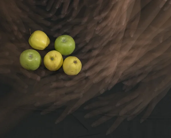 Five apples, green and yellow.hands.