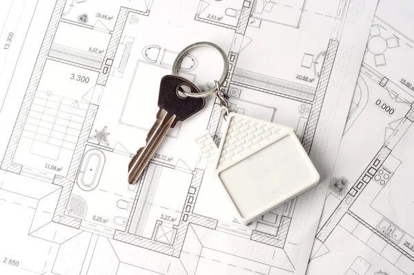 House key on a paper plan — Stock Photo, Image