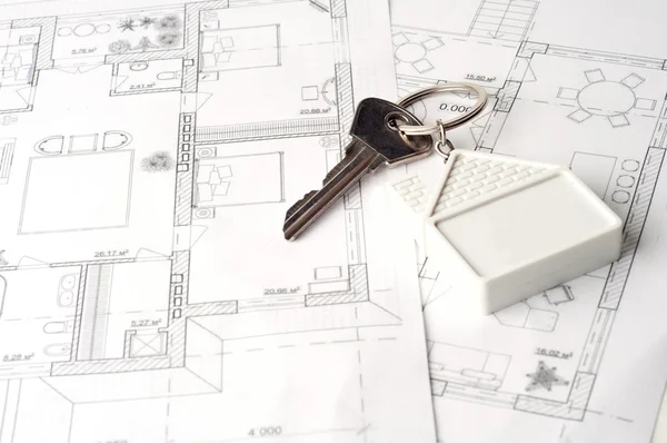 House key on a paper plan Stock Picture