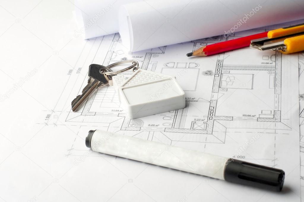 House keys on a house plan blueprint concept for new house desig
