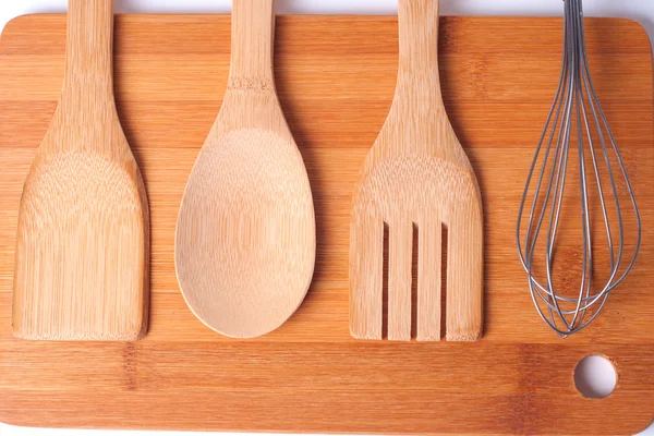 Top view of wooden kitchen utensils on wood board