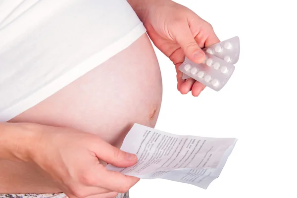 Pregnant woman holding pills. Royalty Free Stock Obrázky