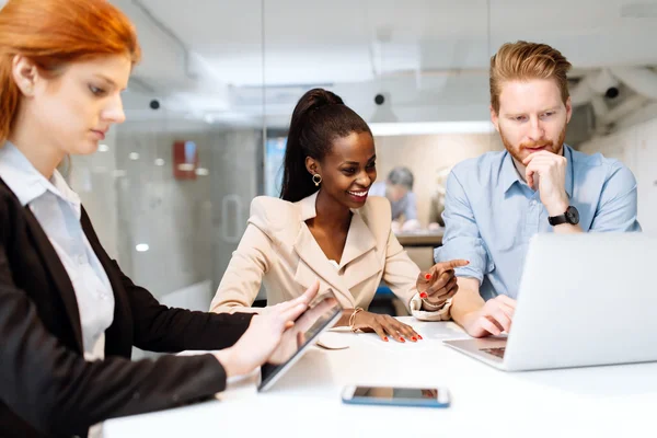 Group of business people sitting at desk — Stock Photo, Image