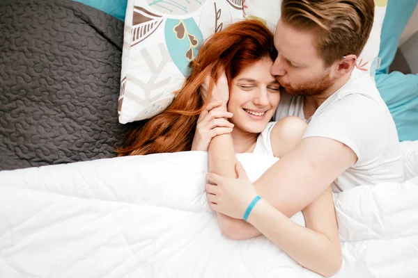 Beautiful happy couple in bed — Stock Photo, Image