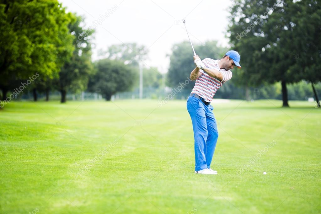 Golfer practicing and concentrating before and after shot during a nice sunny day