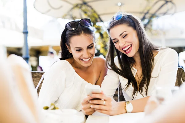 Two young girls talking during lunch break