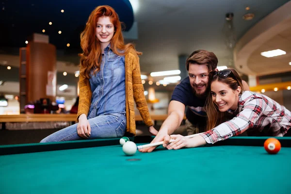 Amigos felizes gostando de jogar piscina — Fotografia de Stock