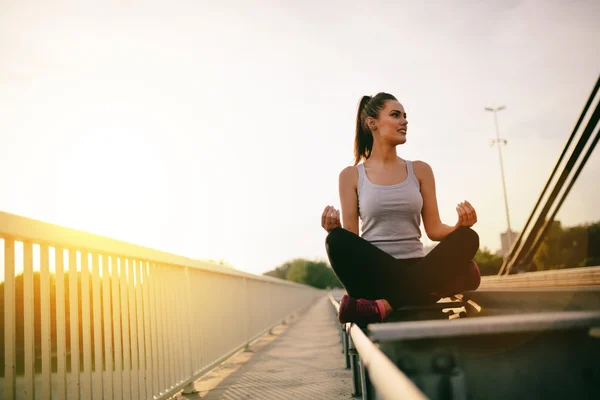 Beautiful woman in lotus position — Stock Photo, Image