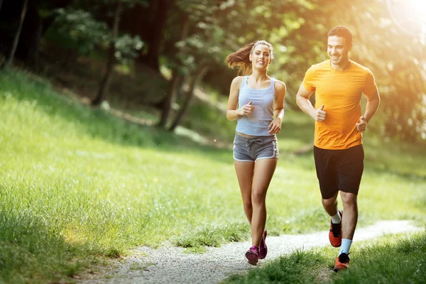 Beautiful couple jogging in nature — Stock Photo, Image