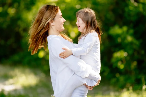 Baby with down sydrome enjoying play — Stock Photo, Image