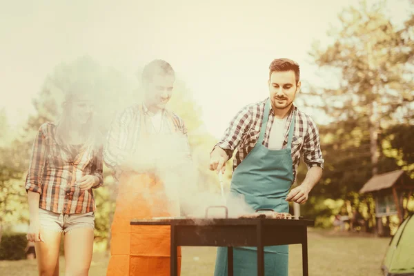 Jongeren genieten van barbecueën — Stockfoto