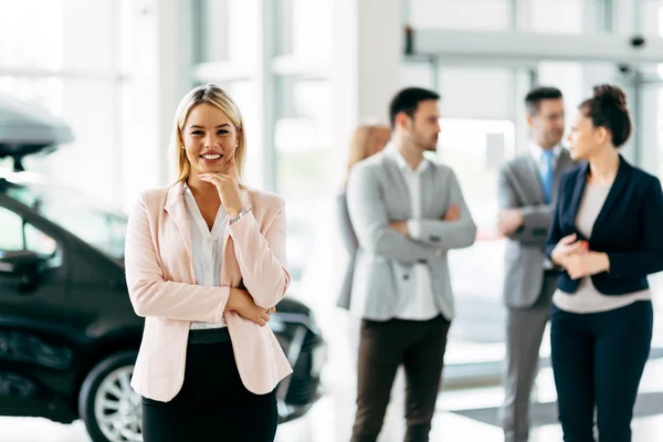 Professional saleswoman at dealership — Stock Photo, Image