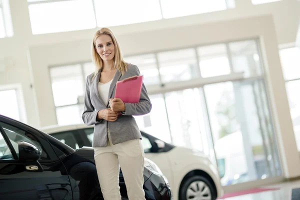 Professional salesperson in car dealership — Stock Photo, Image