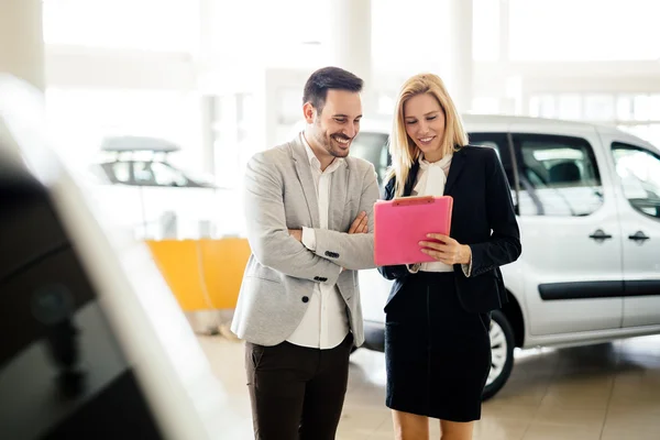 Cliente à procura de um carro na concessionária — Fotografia de Stock