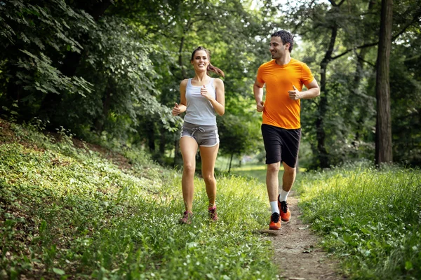 Healthy couple jogging in nature — Stock Photo, Image