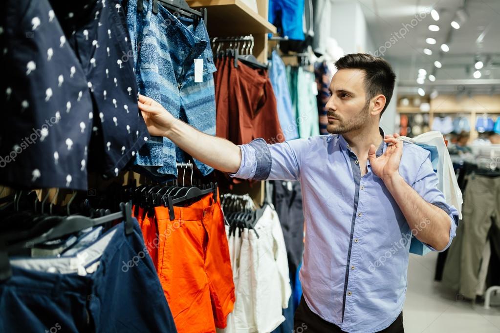 Handsome man shopping for clothes Stock Photo by ©nd3000 117824998