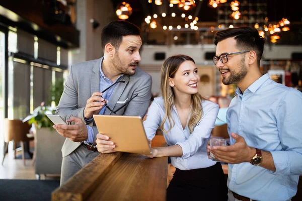 Happy business colleagues having conversation during coffee break