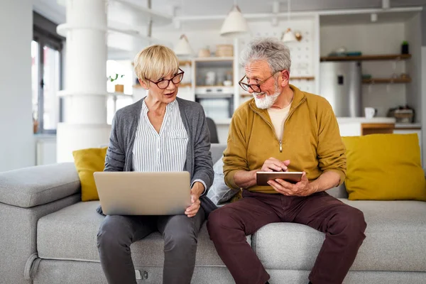 Senior retired couple learn about computer and online support. Technology, people concept