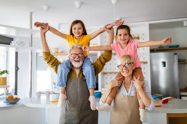 Grandchildren having fun, playing with grandparents at home. Family love generation concept