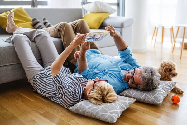 Lovely Smiling Senior Couple Having Fun While Using Tablet Home — Stock Photo, Image