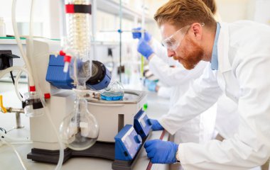 Laboratuvarda test tüpündeki tepkiye bakan bilim adamı..