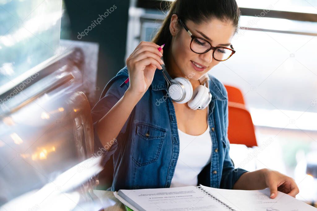 Education, study and home concept. Happy smiling student woman studying, learning for exam