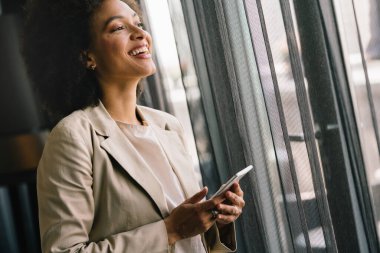 Akıllı telefon kullanan başarılı bir iş kadınının portresi. Mutluluk, iş, teknoloji kavramı.