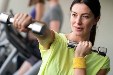 Spor salonunda spor yapan formda ve formda bir kız.