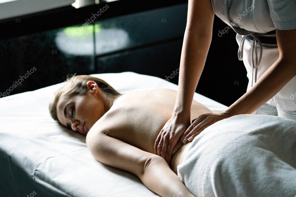 Healthy and beautiful woman in spa. Recreation, health, massage and healing.