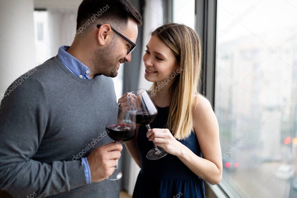 Happy couple in love drinking wine and having romantic date