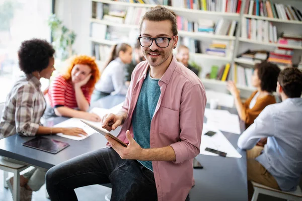 Programmers cooperating working at information technology company