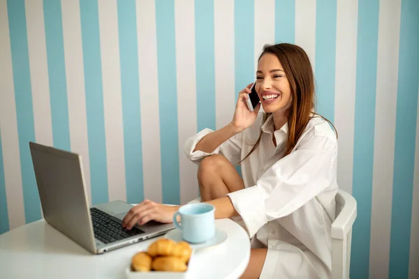 Remote job, technology and people concept. Happy beautiful woman working with laptop computer at home office