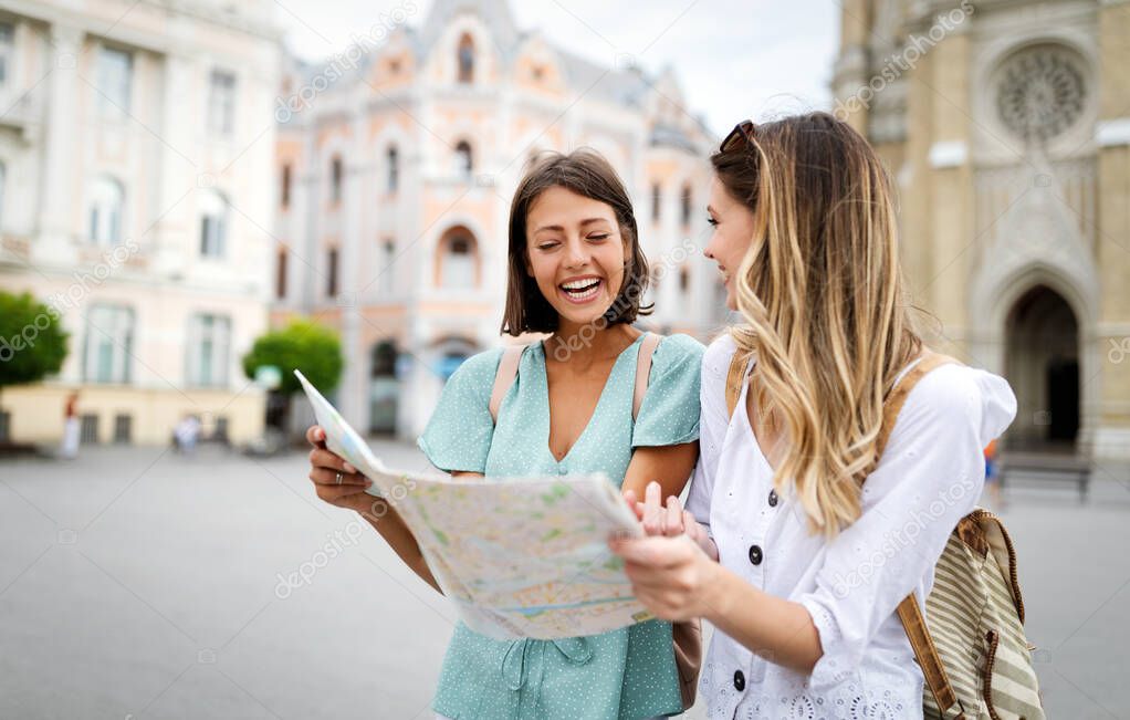 Happy women friends enjoying travel and vacation in the city.