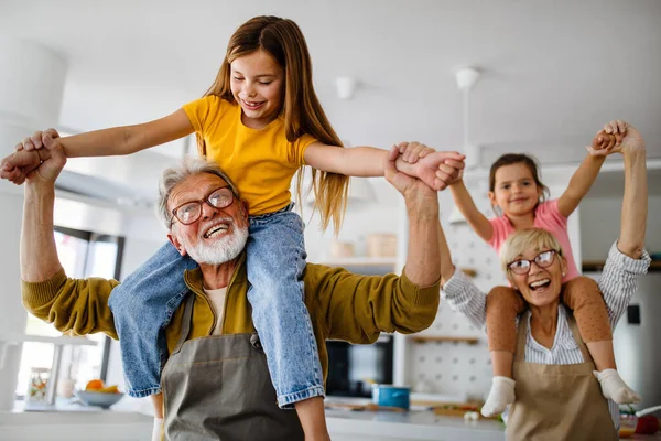 Family, generation and people concept. Happy grandparent having fun with children at home