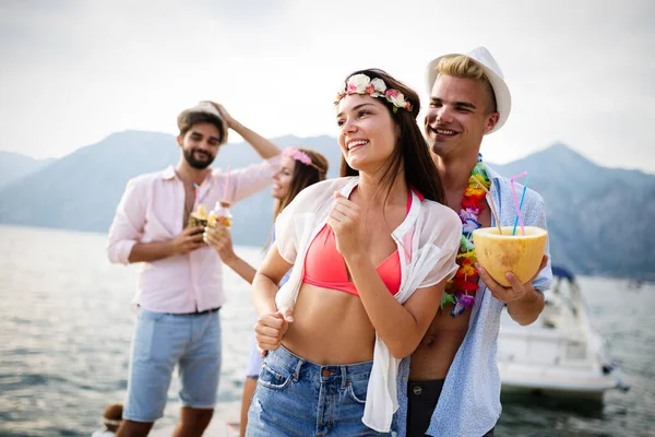 Bir grup arkadaş sahilde dans edip eğleniyorlar. Plajda yaz tatili partisi