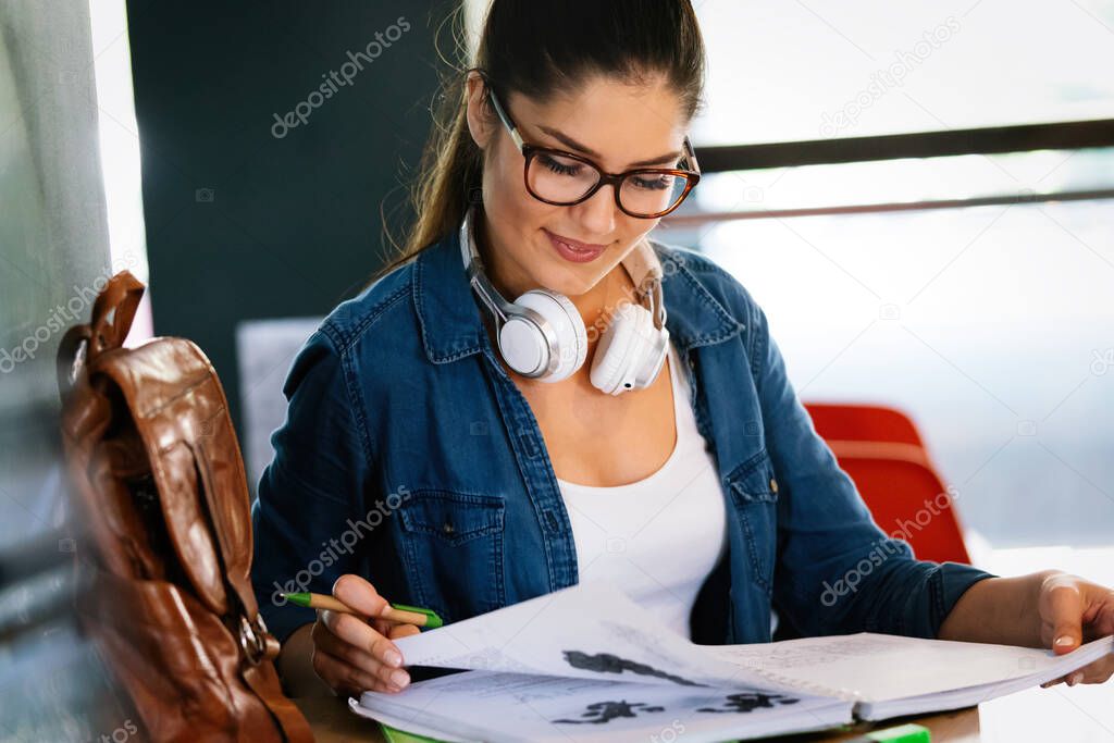 Education, study and home concept. Happy smiling student woman studying, learning for exam
